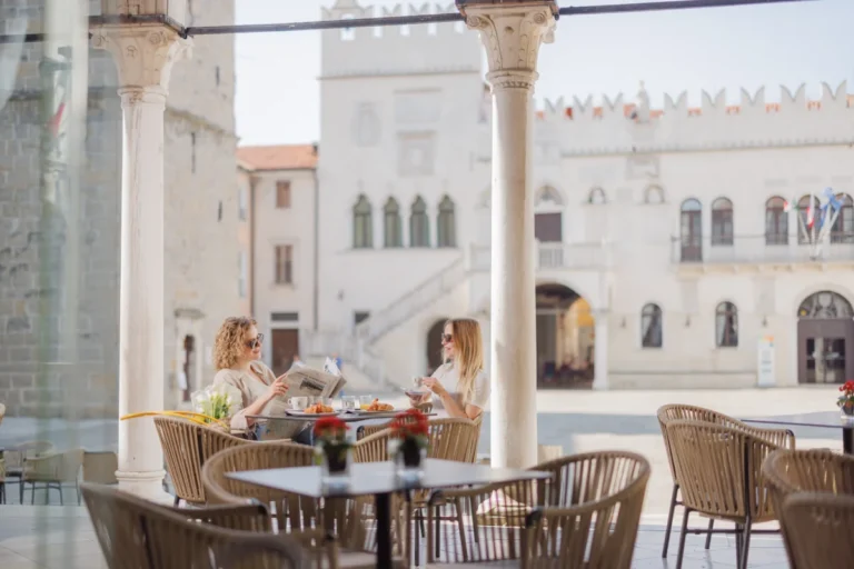 Two friends drinking coffee in the Koper Old Town